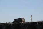 NS 9363 takes a string of flat cars west over Rockville bridge